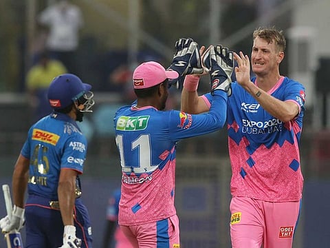 Chris Morris of Rajasthan Royals (right) and his captain Sanju Samson celebrate the wicket of Rohit Sharma, Mumbai Indians captain, in the India leg of IPL 2021.