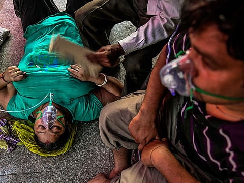 COVID-19 patients receive oxygen at a Sikh gurdwara in Delhi, Sunday, April 25, 2021.