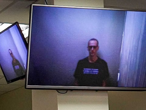 In this photo provided by the Babuskinsky District Court on Thursday, April 29, 2021, Russian opposition leader Alexei Navalny appears on TV screens via a video link from prison, during a hearing on his charges for defamation, in the Babuskinsky District Court in Moscow, Russia.