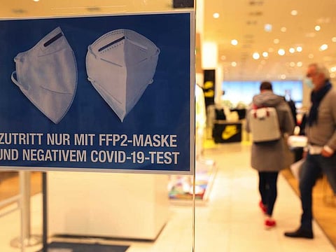 A sign reading 'entry only with FFP2 protective face mask and a negative COVID-19 test' at a store entrance in Mall of Berlin in Berlin, Germany, on Friday, April 30, 2021.