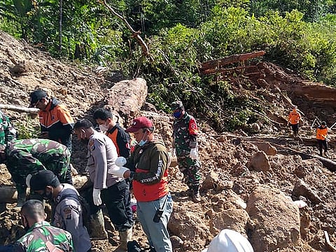 This handout photo taken on April 30, 2021 and released by the Indonesian National Board for Disaster Management (BNPB) shows rescuers searching for survivors after a rain-sparked landslide killed at least three people near a Chinese-backed power plant in Batang Toru in South Tapanuli, North Sumatra