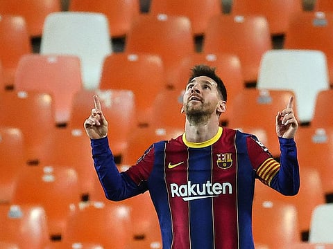 Messi celebrates two goals against Valencia as Barcelona win 3-2.