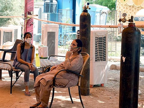 COVID-19 patients use an oxygen cylinder arranged for free by Hemkunt Foundation amid a shortage of Oxygen gases, in Gurugram on Wednesday, May 5, 2021.