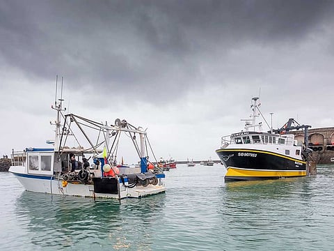 French fishing vessels block the port of St Helier in Jersey, Thursday, May 6, 2021. French fishermen angry over loss of access to waters off their coast have gathered their boats in protest off the English Channel island of Jersey.