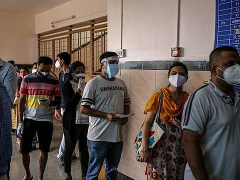 People wait in line at a COVID-19 vaccination centre at a municipal hospital in Pune, Maharashtra, India, on Wednesday, May 5, 2021.