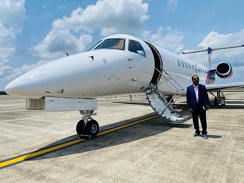 P.D. Syamalan in front of the private jet in which he flew from India to the UAE with his family on Friday.