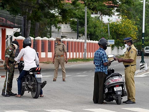 Police personnel make inspections during a lockdown imposed to prevent the spread of COVID-19, in Thiruvananthapuram on Tuesday, May 4, 2021.