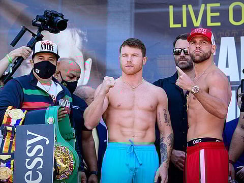 Canelo Alvarez and Billy Joe Saunders pose for the fans during weigh ins for their super middleweight boxing title fight at AT&T Stadium.