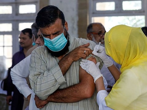 A man receives a dose of a coronavirus disease vaccine, at a vaccination center in Karachi, Pakistan April 28, 2021.