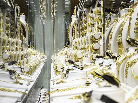 Gold jewelry on display in a shop window in the Gold Souk in the Deira district of Dubai, United Arab Emirates