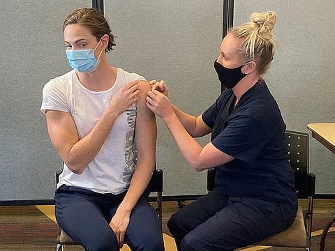 Swimmer Cate Campbell receives a Pfizer COVID-19 vaccination at the Queensland Academy of Sport in Brisbane