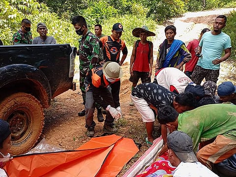 Rescuers retrieving bodies after a landslide at a gold mine in south Solok, West Sumatra province, where at least seven people were killed and one reported missing.