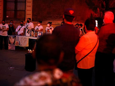 Mothers stand near photographs of their missing daughters during a protest on Mother's Day in Ciudad Juarez, Mexico May 10, 2021.