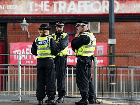 Police are deployed in force outside the Old Trafford stadium in Manchester, ahead of the English Premier League match against Leicester City