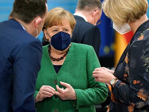 From left, German Health Minister Jens Spahn, German Chancellor Angela Merkel and German Science and Education Minister Anja Karliczek talk as they arrive for the weekly cabinet meeting at the Chancellery in Berlin, Germany, Wednesday, May 12, 2021.