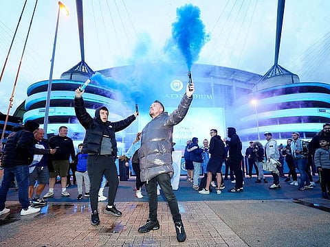 Manchester City fans celebrate outside the Etihad