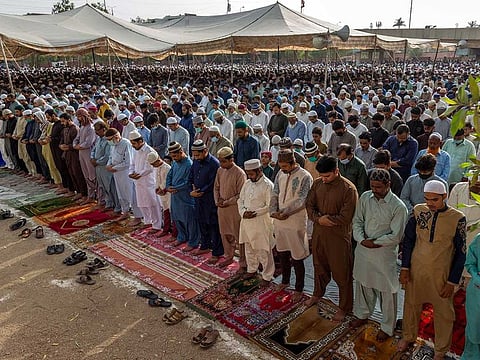People gather to offer Eid Al Fitr prayers in Karachi, Pakistan, on Thursday, May 13, 2021.