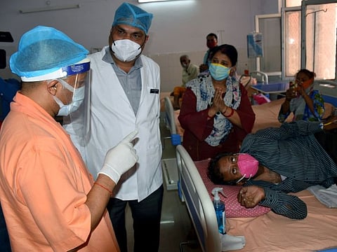 Uttar Pradesh Chief Minister Yogi Adityanath interacts with COVID-19 patients at District Hospital in Mathura on Thursday.