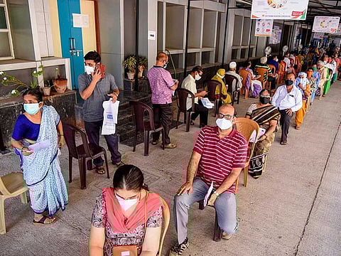 Citizens wait in a queue to receive a dose of coronavirus vaccine in India. The second wave has given new impetus to the vaccine drive.