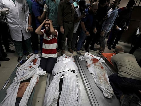 Relatives of the Abu Hatab family mourn over the bodies of their family members in Al Shifa Hospital, after an Israeli air strike struck their house located in Al Shati Refugee Camp without warning during the night, in Gaza City early on May 15, 2021. Te members of the family were killed, including 8 children.