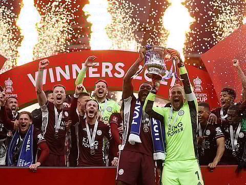 Leicester City's Kasper Schmeichel and Leicester City's Wes Morgan celebrate with the trophy after winning the FA Cup.