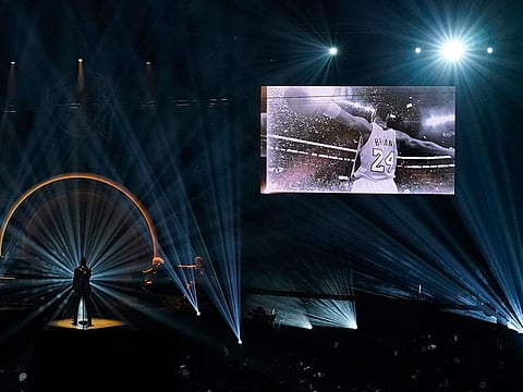 A image of Kobe Bryant is projected on a video screen above the stage as Ne-Yo sings at the 2020 Basketball Hall of Fame ceremony
