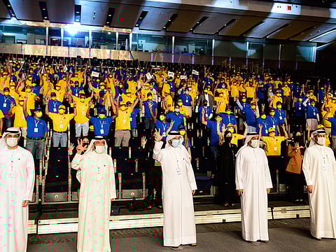 Major General Obaid Muhair bin Suroor (third left) Chairman of Taqdeer Awards and Deputy Director General of GDRFA Dubai with offials pose for a photo with workers from companies at the 4th cycle of Taqdeer Award at Dubai World Trade Centre on Monday.