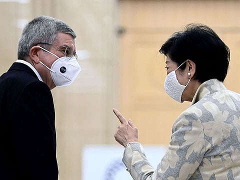 Tokyo Governor Yuriko Koike speaks to International Olympic Committee president Thomas Bach
