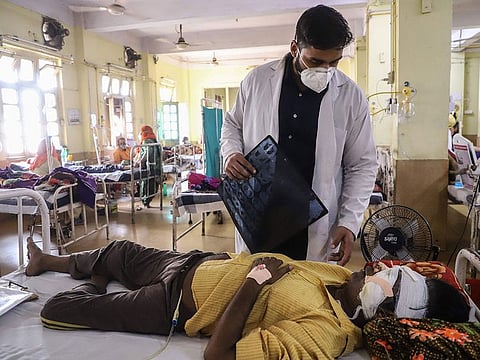 A doctor assists a COVID-19 patient with black fungus as he receives treatment at the NSCB hospital in Jabalpur, India.