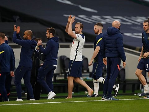 Tottenham Hotspur's star striker Harry Kane (white) and teammates gesture to fans refusing to leave after they slumped to a 2-1 loss to Aston Villa at the Tottenham Hotspur Stadium in London on Wednesday.
