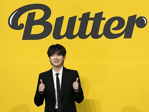 SUGA, a member of South Korean K-pop band BTS, poses for photographers ahead of a press conference to introduce their new single "Butter" in Seoul, South Korea, Friday, May 21, 2021.