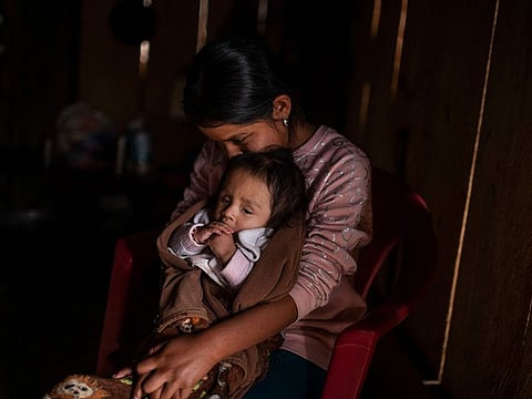 Cristina Moreno, 18, holds her baby at her home in Juvinani village, Metlatonoc municipality, Guerrero state, Mexico, on May 16, 2021.