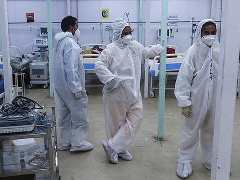 Health workers keep a watch on patients in a ward at the BKC jumbo field hospital, one of the largest COVID-19 facilities in Mumbai, India, Friday, May 7, 2021.