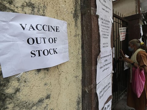 In this April 8, 2021 file photo, a note informing about the non-availability of COVID-19 vaccine is seen pasted on a wall of a vaccination centre in Mumbai. India, the world’s largest maker of vaccines, was expected to play a pivotal role in global efforts to immunise against COVID-19. But its own capacity is proving to be insufficient for its own massive needs amid a ferocious surge of new infections.