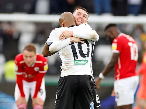 Swansea City's Matt Grimes and Andre Ayew celebrate after defeating Barnsley