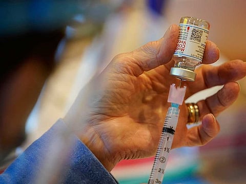 In this Dec. 29, 2020, file photo, Pat Moore, with the Chester County, Pennsylvania, Health Department, fills a syringe with Moderna COVID-19 vaccine before administering it to emergency medical workers and health care personnel at the Chester County Government Services Centre in West Chester, Pennsylvania.