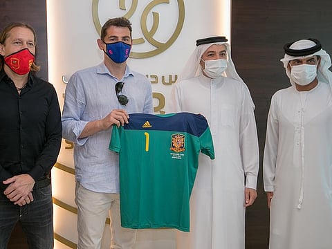 Iker Casillas (second left) hands over his Spain team shirt as a souvenir to Nasser Aman Al Rahma, Assistant Secretary General and Ali Omar, Director of Sports Development during his visit to Dubai Sports Council headquarters. Michel Salgado, Casillas' compatriot and a former Real Madrid player, is on far left.