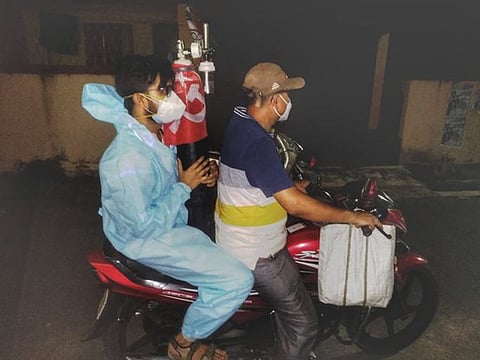 Night vigil: Two members of the Red Volunteers group set out to reach an oxygen cylinder at the dead of night in Kolkata.