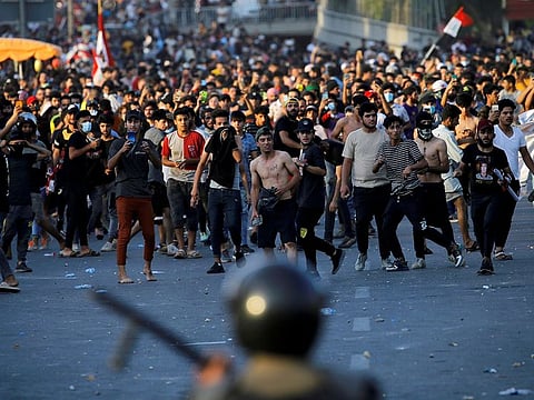 Demonstrators face security forces during an anti-government protest in Baghdad, Iraq May 25, 2021.
