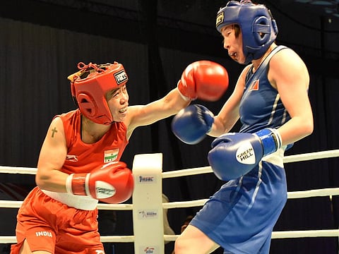 India's M.C. Mary Kom (left) looks to land a punch against Mongolian Lutsaikhan Altantsetseg en route to her semi-final win in 51 kg class in Dubai.