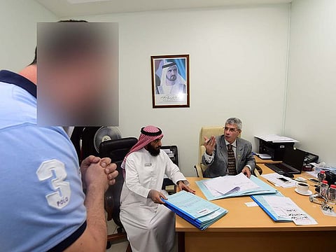 Aymen Mohammed Abdul Hakeem with Fazal Rabbi Mohammed Amir, head Judicial Translator, Dubai Courts, at Al Muraqqabat Police Station.
