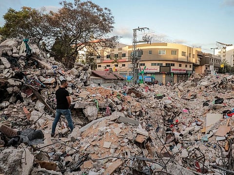 Al Ouf observes the rubble of his home where his sisters and other relatives were killed by an Israeli air strike in Gaza City, Gaza Strip, May 21, 2021.