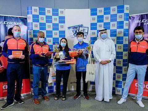 Mr Cricket UAE Anis Sajan and Abdul Hamid, CEO, EIC & Executive Director Publications, accompanied by Gulf News staff Shyam A. Krishna, Senior Associate Editor, and Matthew Smith, Sports Editor, present the trophy along with other gifts to the winners Maaz Ahmed and Heta Khan from Delhi Capitals, after the IPL 2021 Quiz by Gulf News and Mr Cricket UAE in Dubai