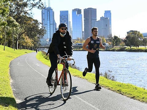 People exercise in Melbourne on June 2, 2021 with the coronavirus lockdown of Australia's second-biggest city to be extended by another seven days, authorities announced as they attempt to stamp out a cluster of cases in Melbourne.