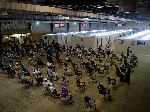 People wait for their turn to receive a dose of the COVID-19 coronavirus Sinovac vaccine at a vaccination camp organised at expo centre in Karachi on June 3, 2021, as the head of a Pakistani province ordered that government employees who refuse to be vaccinated would not be paid from next month.