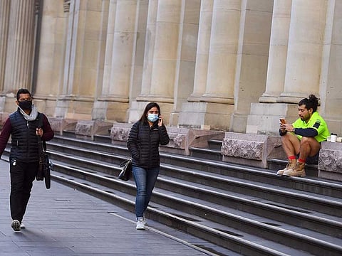 People walk down Melbourne's normally bustling city centre on June 4, 2021, as the coronavirus lockdown of Australia's second-biggest city is extended by another seven days, authorities announced.