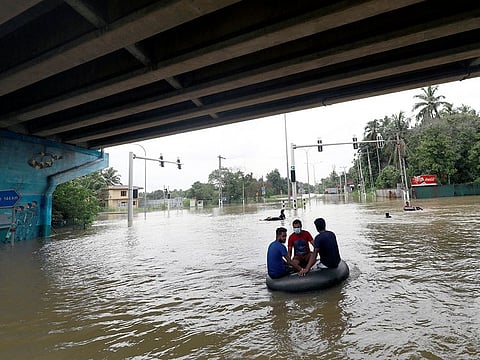 Men float on a tube down a flooded road during a COVID-19 curfew in Kaduwela, a suburb town of Colombo, Sri Lanka June 6, 2021