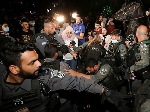 Prominent Palestinian activist Muna Al Kurd reacts during scuffles with Israeli police amid ongoing tension ahead of an upcoming court hearing in an Israeli-Palestinian land-ownership dispute in the Sheikh Jarrah neighbourhood of East Jerusalem, May 4, 2021.