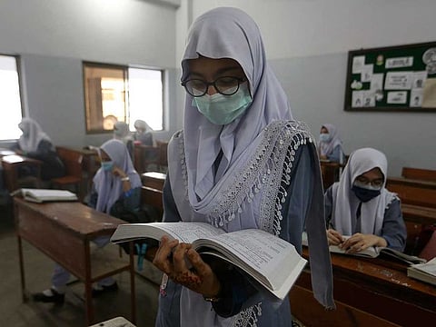 A student wears a face mask to help prevent the spread of the coronavirus while attending class at a school, in Karachi, Pakistan, Monday, June 7, 2021.