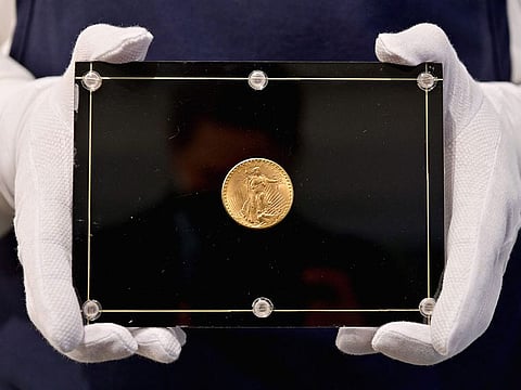 A Sotheby’s employee holds a 1933 Double Eagle Coin during the "Three Treasures – Collected by Stuart Weitzman," a dedicated live auction, of three treasures from the personal collection of the fashion designer and collector.